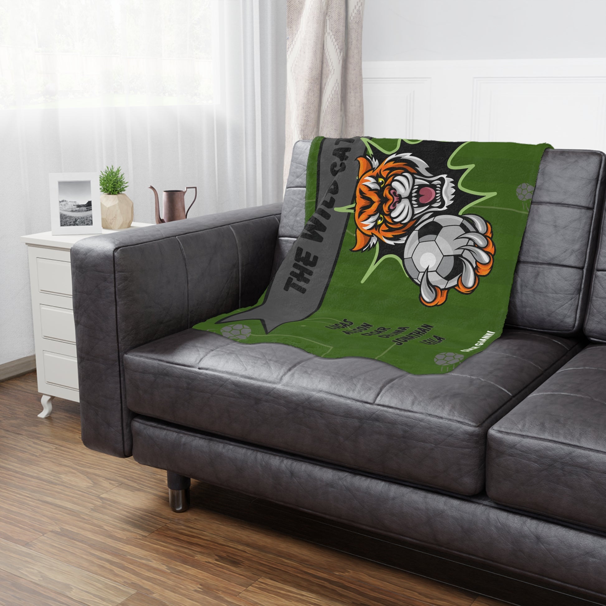 Tiger soccer team banner blanket hanging on side of brown leather couch