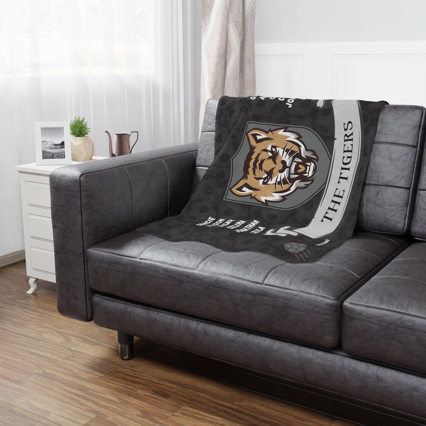 Wild cat soccer team banner blanket hanging on side of brown leather couch