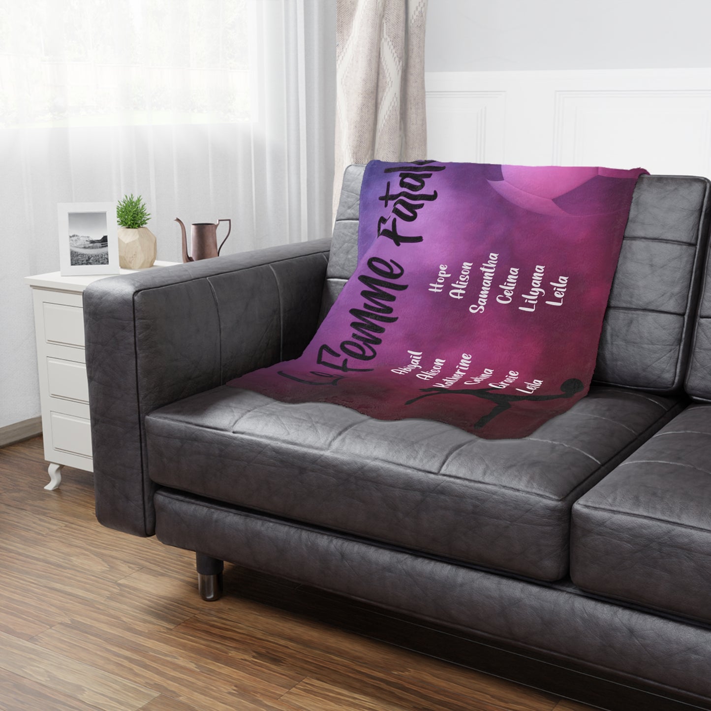 Female soccer team banner blanket hanging on side of brown leather couch