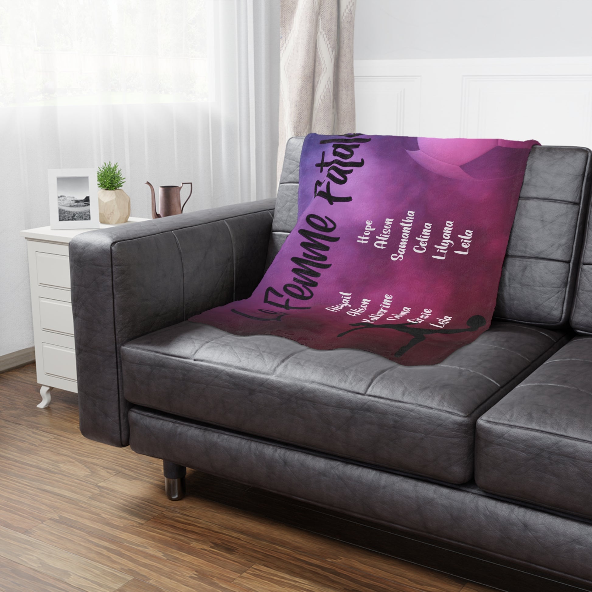 Female soccer team banner blanket hanging on side of brown leather couch