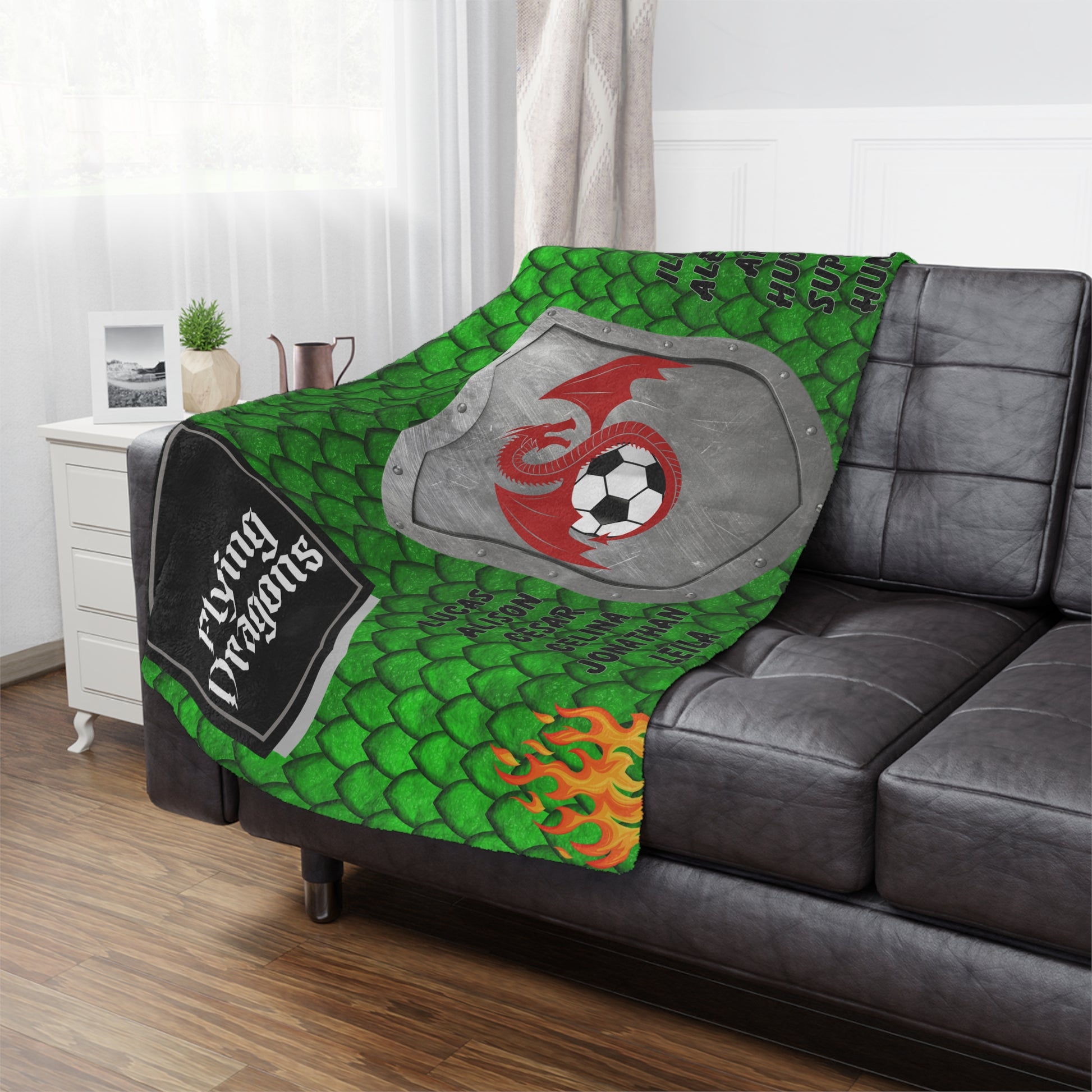 Red dragon mascot soccer team banner blanket hanging on side of brown leather couch