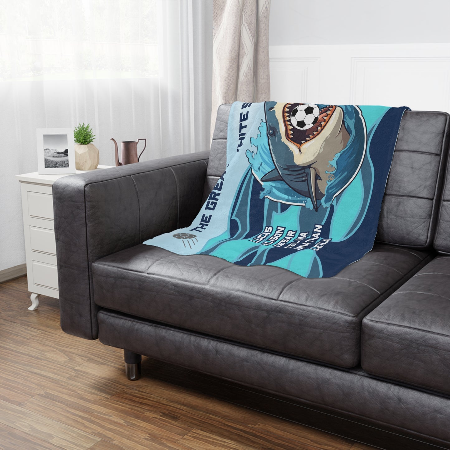 Shark soccer team banner blanket hanging on side of brown leather couch