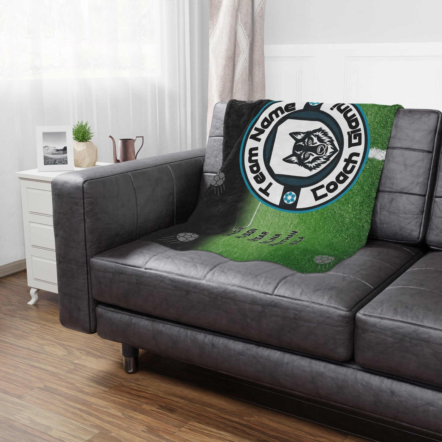 Wolf soccer team banner blanket hanging on side of brown leather couch