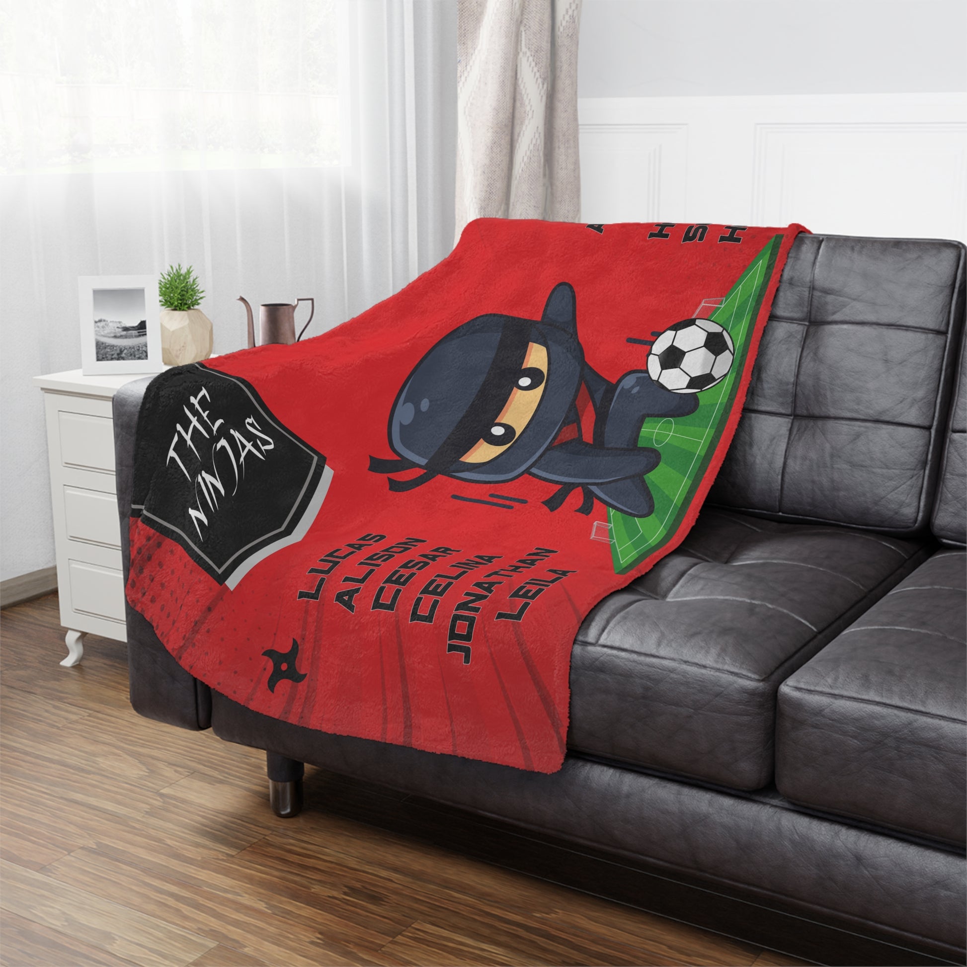  Ninja soccer team banner blanket hanging on side of brown leather couch