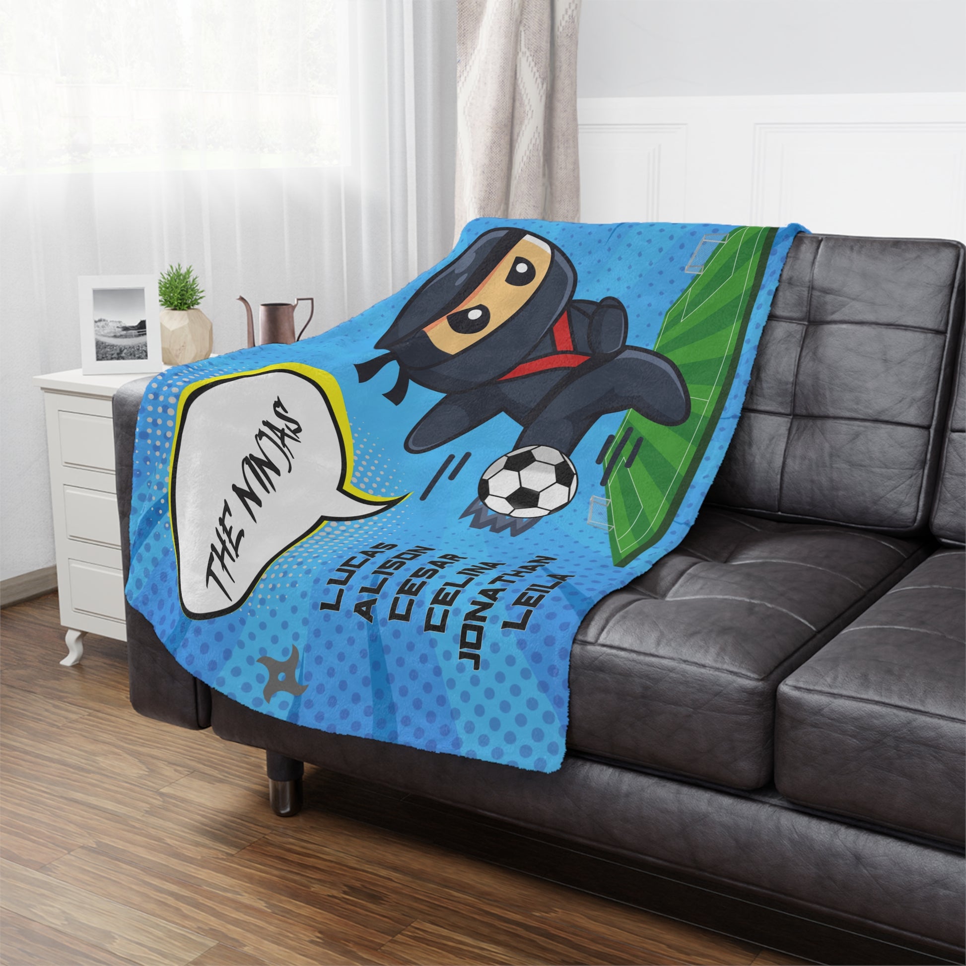 Blue background Ninja soccer team banner blanket hanging on side Ninja soccer team banner blanket hanging on side of brown leather couchbrown leather couch